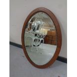 A carved walnut framed oval mirror