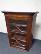 A George III mahogany hanging corner cabinet with astragal glazed doors