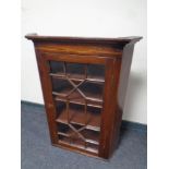 A George III mahogany hanging corner cabinet with astragal glazed doors