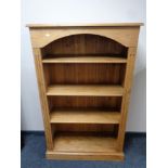 A set of stripped pine open bookshelves,