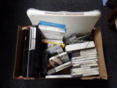 A box containing Nintendo Wii and Wii Fit board, Play Station III, Play Station II, three games,