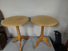 A pair of contemporary pine circular tripod tables