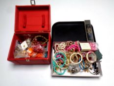 A tray containing a red faux leather jewellery box containing a large quantity of costume jewellery