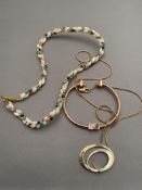 A beaded necklace together with a bangle in rose gold coloured finish,