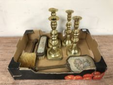 Two pairs of antique brass candlesticks together with a needlepoint three piece dressing table set