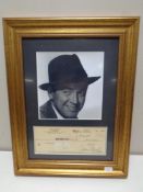A James Stewart signed cheque to the US Air Force mounted and framed with monochrome photograph