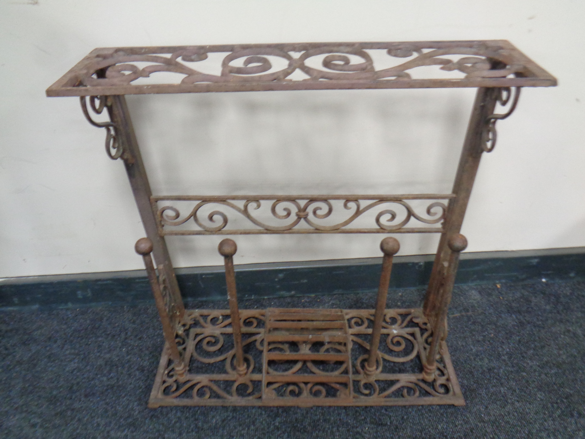 A wrought iron boot stand