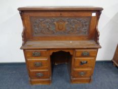 A 19th century carved oak Arts and Crafts secretaire desk, height 118 cm,
