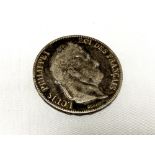 An 1857 silver five franc coin