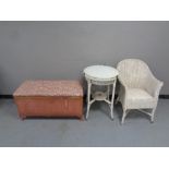 A Lloyd loom glass topped circular occasional table together with a loom basket chair and blanket