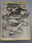 A collection of silver plated sugar tongs