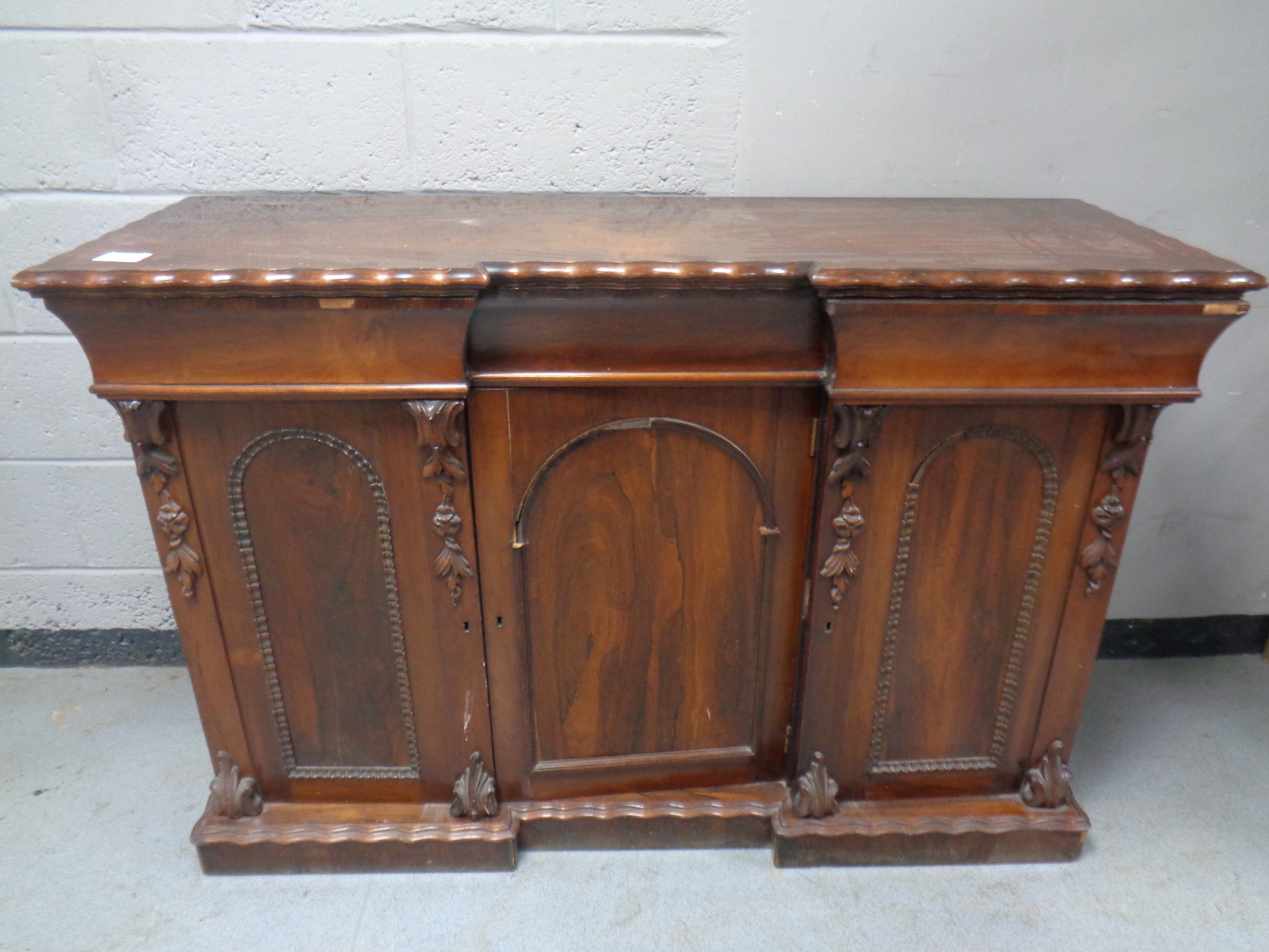 A 19th century rosewood triple door break front chiffonier base,