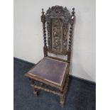 A 19th century heavily carved oak barley twist hall chair