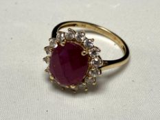 A 9ct gold ruby and cubic zirconia cluster ring