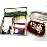 A collection of costume jewellery to include faux pearls, brooches, wristwatch,