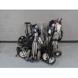 A quantity of assorted folding golf trolleys together with a golf bag,