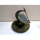 A bronze sundial mounted on a circular stone base