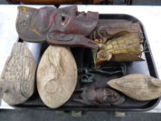 A tray containing assorted wooden carvings to include eastern face masks, ducks etc,