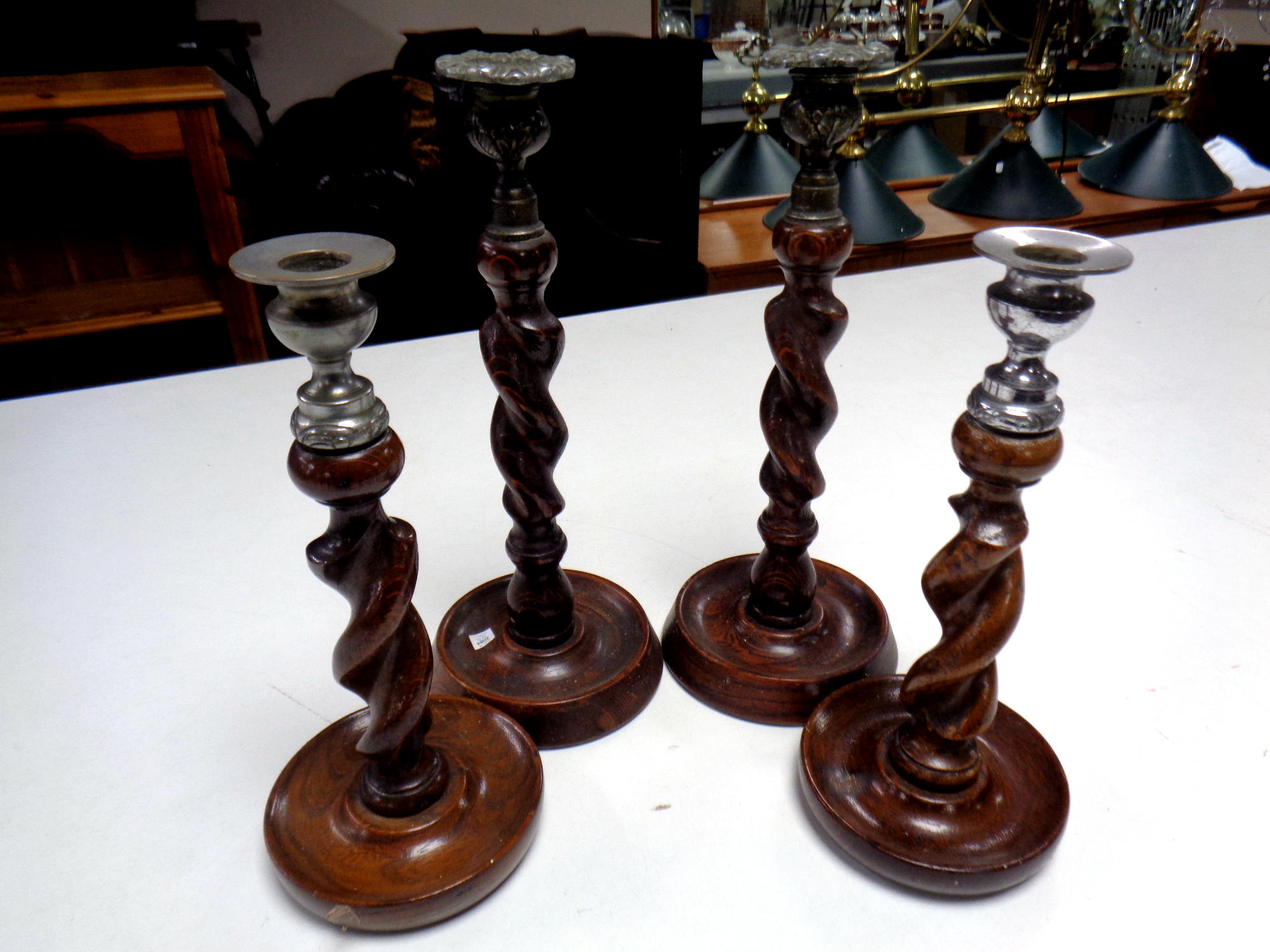 Two pairs of Edwardian barley twist candlesticks