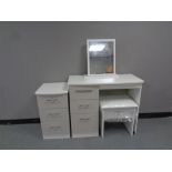 A contemporary white single pedestal knee hole dressing table with mirror and stool and matching