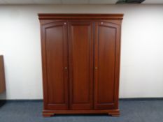 An Olympus Furniture cherry wood triple door wardrobe, 158cm wide by 65cm deep by 199cm high.