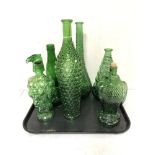 A collection of green coloured glass bottles