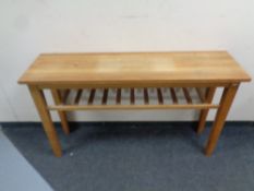 A contemporary oak hall table with under shelf,