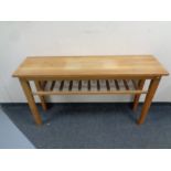 A contemporary oak hall table with under shelf,