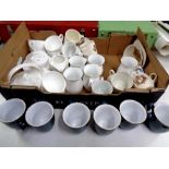 A box containing assorted ceramics to include Denby mugs, white china mugs,