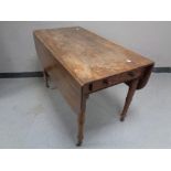 A Victorian mahogany Pembroke table fitted drawers (lacking caster),