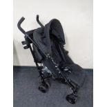 A Mamas and Papas Voyage folding push chair with rain cover