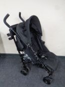 A Mamas and Papas Voyage folding push chair with rain cover
