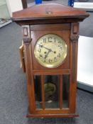 An early 20th century mahogany wall clock with silvered dial