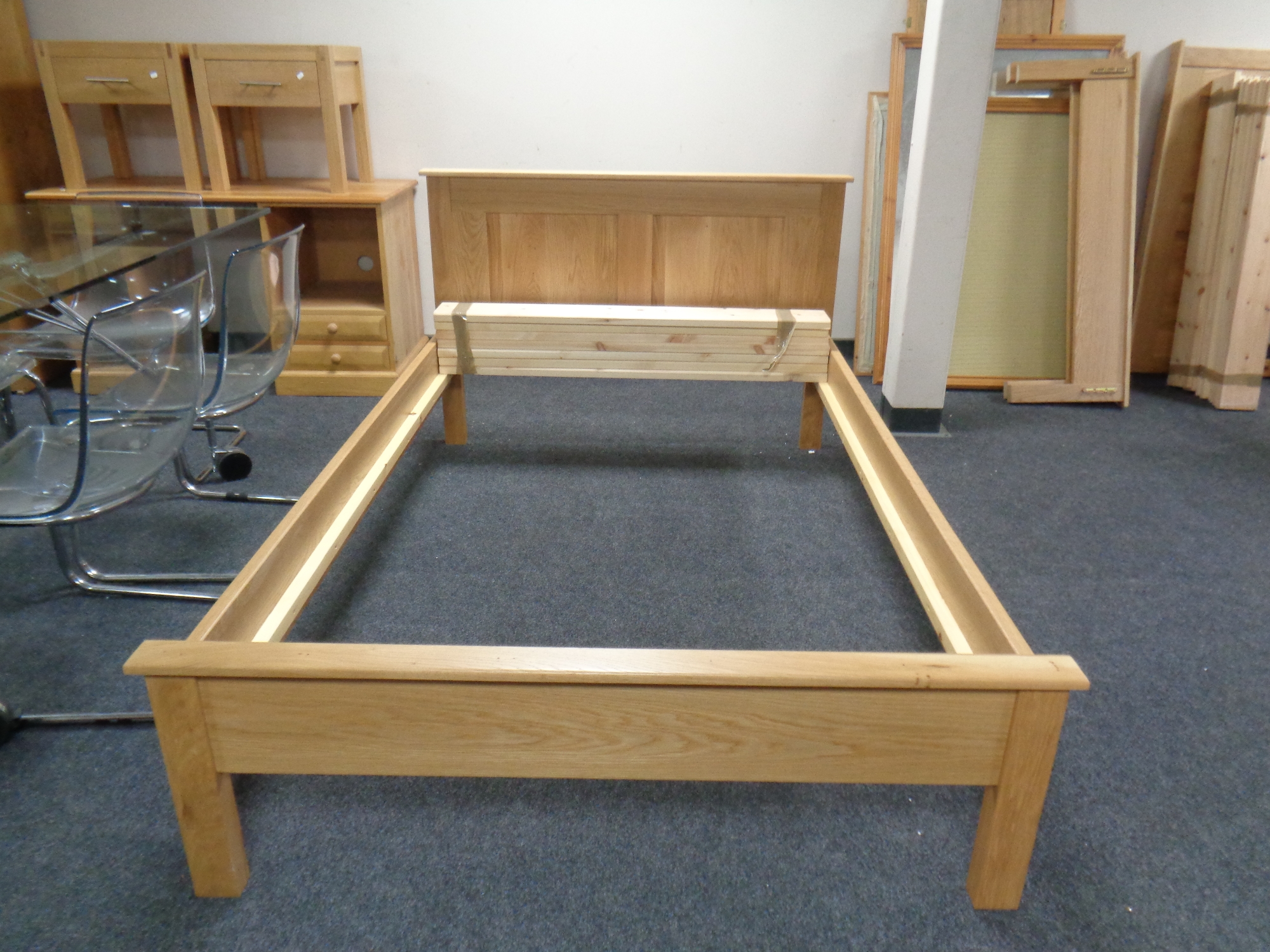 A contemporary oak 4 ft bed frame with mattress slats