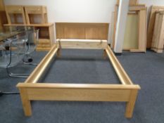 A contemporary oak 4 ft bed frame with mattress slats