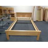 A contemporary oak 4 ft bed frame with mattress slats