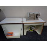A New Home model 535 electric sewing machine in cabinet