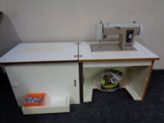 A New Home model 535 electric sewing machine in cabinet