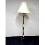 A brass and onyx standard lamp with shade