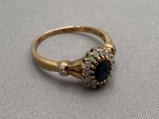 A 9ct gold diamond and sapphire ring