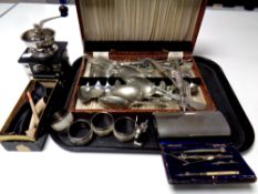 A tray containing coffee grinder, canteen of cutlery, boxed pipe,