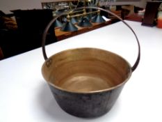 A 19th century copper cast iron handled jam pan