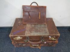 Two antique leather luggage cases together with a leather briefcase