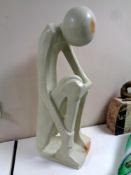 A polished stone abstract sculpture, seated figure, height 62.