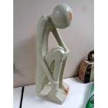 A polished stone abstract sculpture, seated figure, height 62.