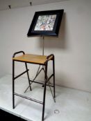 A 20th century school stool together with a folding music stand and a watercolour depicting figures,