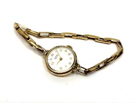 A 9ct gold lady's Vertex wristwatch on 9ct gold expansion strap, 15.