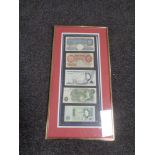 A frame containing five English bank notes