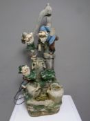 A gnome garden water feature together with two painted concrete garden figures,
