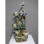 A gnome garden water feature together with two painted concrete garden figures,